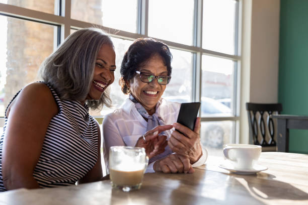 istock Cheerful women look at smartphone together 1176649502