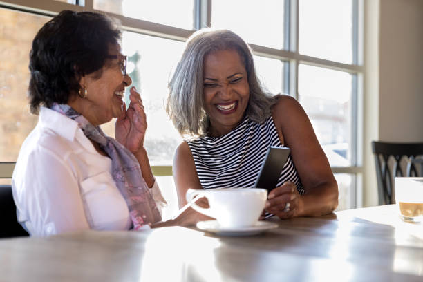 istock Senior women laugh while looking at smartphone 1176649518