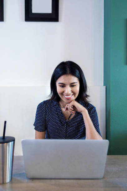 istock Female college student studies alone in cafe using laptop 1176650605