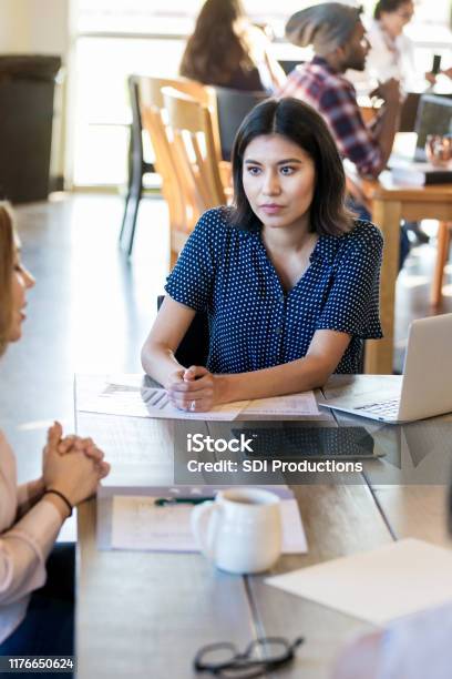After Presentation Business Woman Listens To Critique From Colleague Stock Photo - Download Image Now