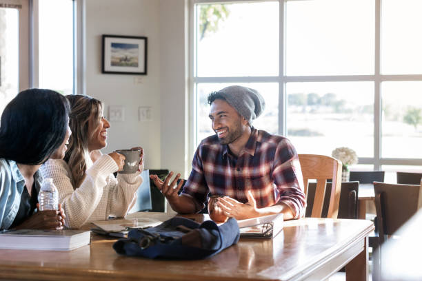 istock Friends meet at coffee shop to study and talk 1176650746