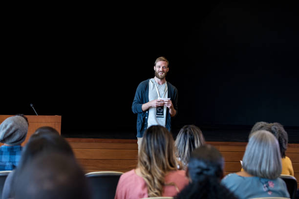 istock Confident young man kicks off conference with welcome speech 1176650806