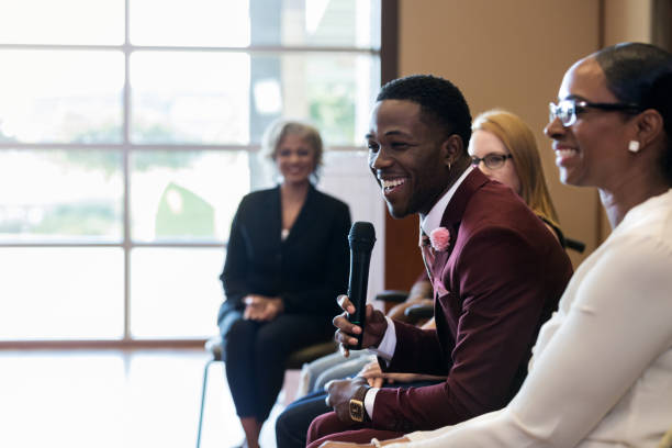 istock Cheerful young businessman smiles while participating in panel discussion 1176650831