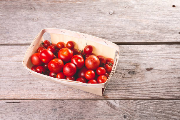 istock ripe tomatoes in a small wooden crate 1176653574