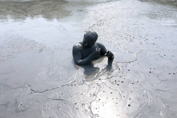 Man shows his hand on the footprints of wolf or a dog, close up
