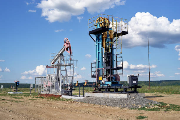 istock Oil pump, field, blue cloudy sky 1176657709