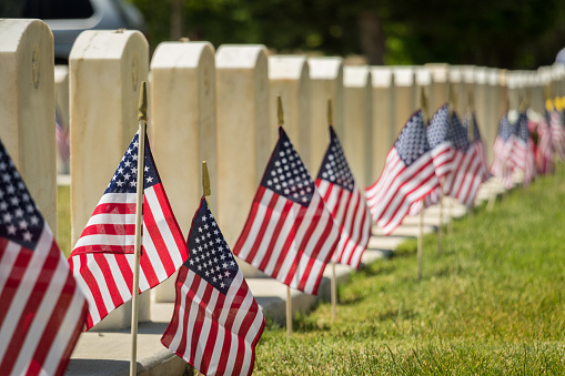 Military headstones decorated with American flags for Memorial Day