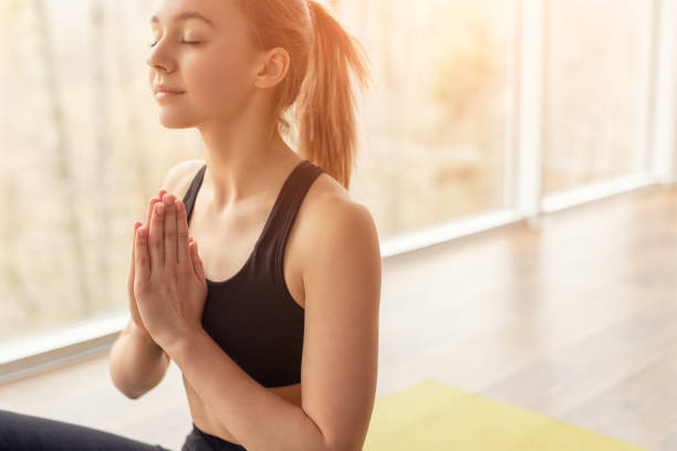 istock Woman meditating with closed eyes in bright light 1176660338