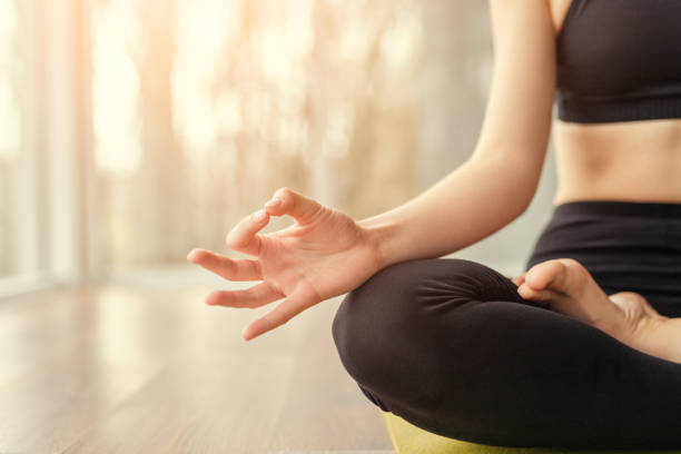 istock Crop woman meditating on floor 1176660372