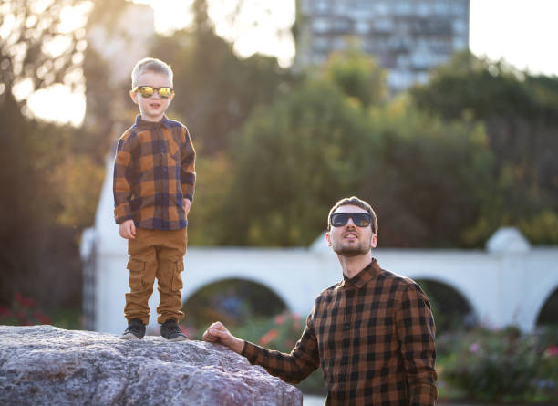 istock A young dad walks with his three-year-old son. 1176661778