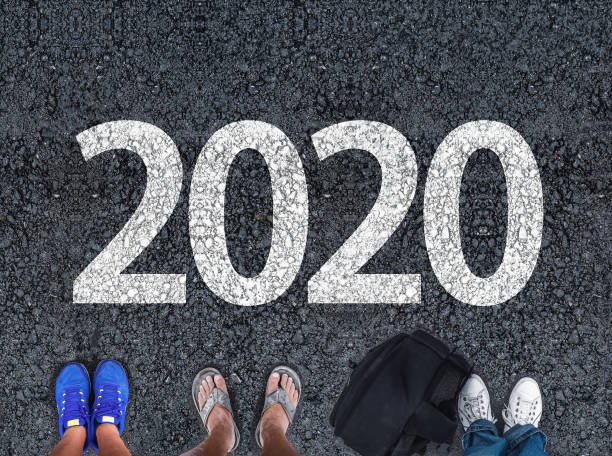 istock people legs standing on asphalt road next to number 2020 1176662659
