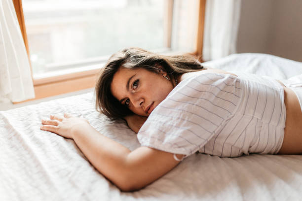 istock Pensive and attractive sad woman lying on the bed. Thinking about problems. Copyspace. Feeling worried, hurt, heartbroken lonely 1176670069