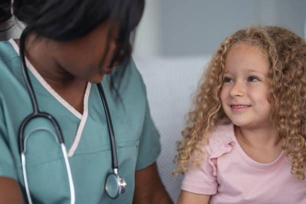 istock Kind nurse comforts child patient 1176673781