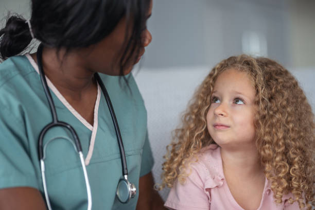 istock Kind nurse comforts child patient 1176673783