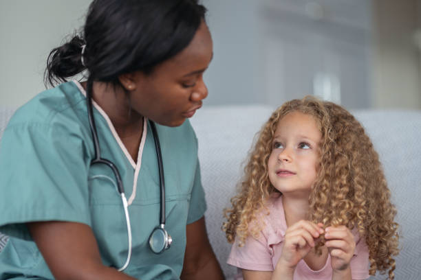 istock Kind nurse comforts child patient 1176673784