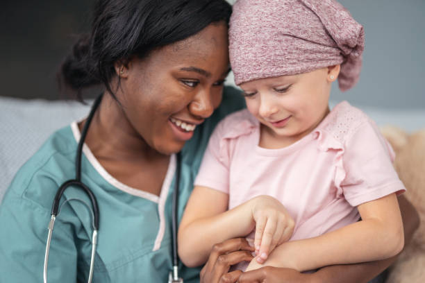 istock Kind doctor comforts girl with cancer 1176673797
