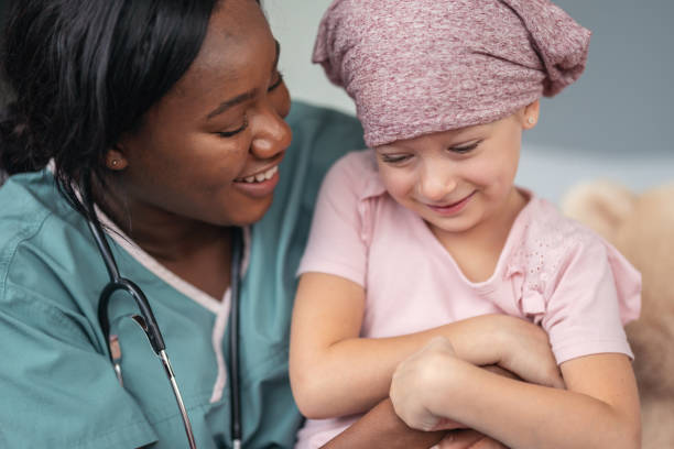 istock Kind doctor comforts girl with cancer 1176673798