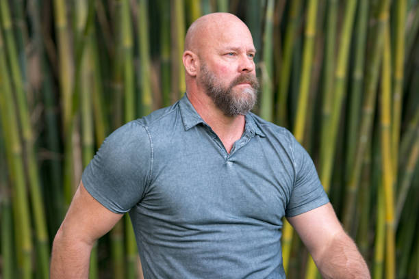 istock Tough guy looking away from camera. Bald head with full beard 1176675577