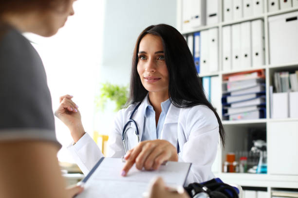 istock Beautiful caucasian female GP pointing finger in application form 1176676601