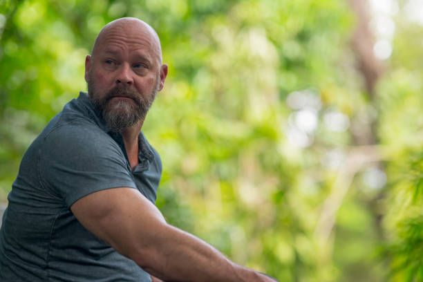 istock Man sitting and looking over shoulder. Copy space on the right of the image 1176676663