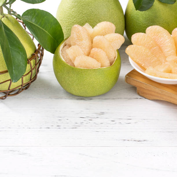 istock Fresh peeled pomelo, pummelo, grapefruit, shaddock on bright wooden table background. Seasonal fruit for Mid-Autumn Festival. 1176676666