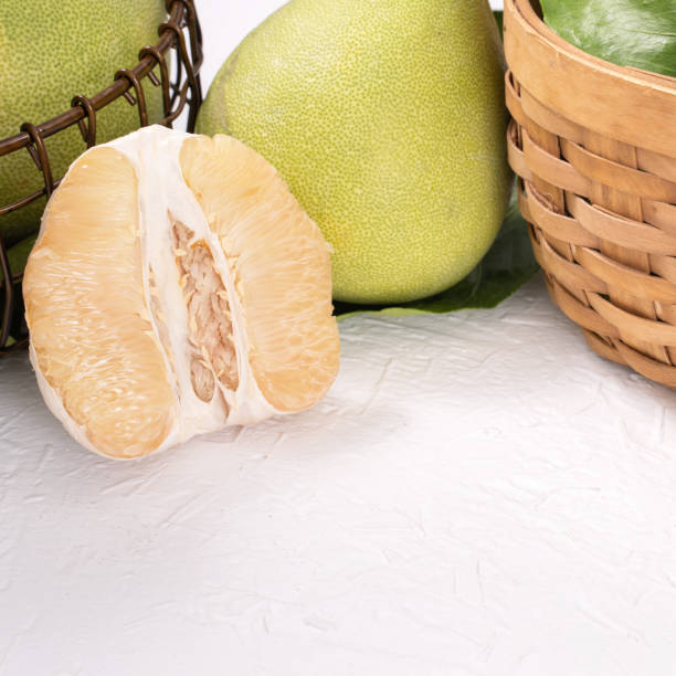 istock Fresh peeled pomelo, pummelo, grapefruit, shaddock on bright wooden table background. Seasonal fruit for Mid-Autumn Festival. 1176676678