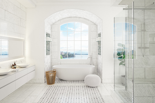 Stylish bathroom interior with ceramic tub, terry towels and houseplant