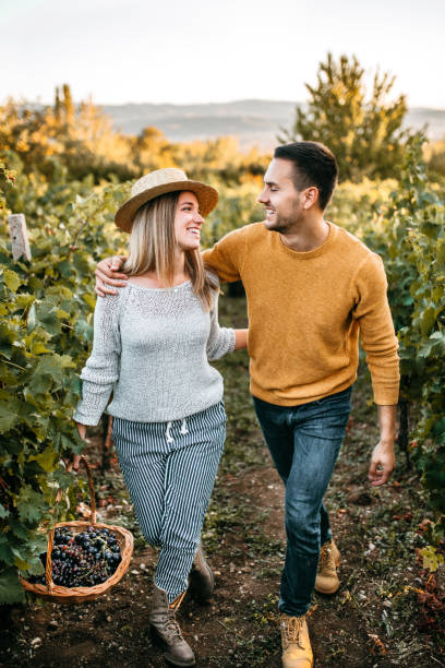 istock Happy couple walking through vineyard 1176678074