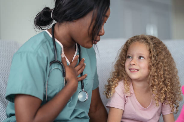 istock Kind nurse comforts child patient 1176678086
