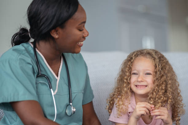 istock Kind nurse comforts child patient 1176678087