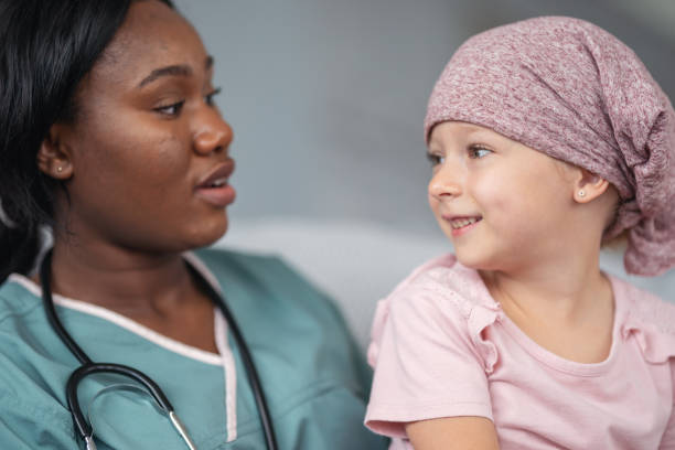 istock Kind doctor comforts girl with cancer 1176678094