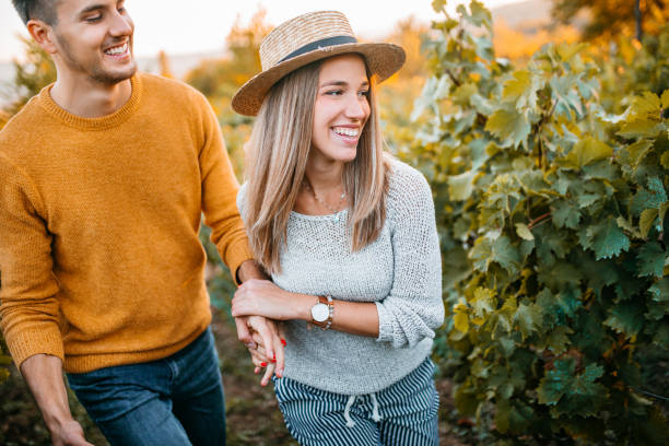 istock Happy couple walking through vineyard 1176678212