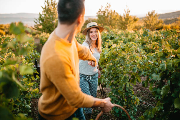 istock Happy couple walking through vineyard 1176678251