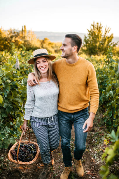 istock Happy couple walking through vineyard 1176678305