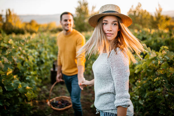 istock Happy couple walking through vineyard 1176678886