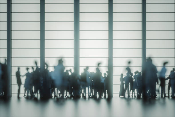 istock Group of people against modern glass facade 1176681634