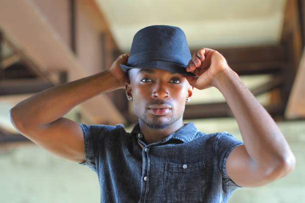 istock young man holding hat attractive people handsome african guy 1176684058