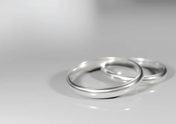 istock pair of silver wedding rings on white floor 1176684966