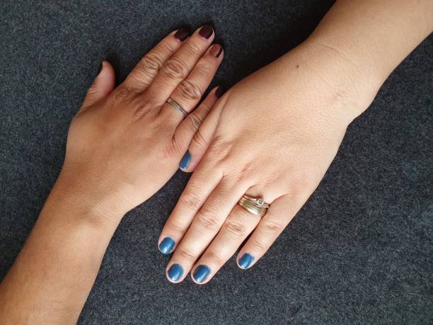 istock hands of dark skinned and light skinned women 1176688952