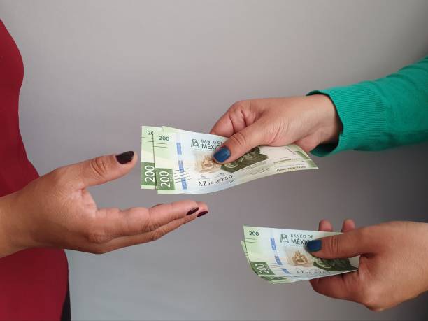 women hands paying and receiving mexican money background for business, economics and finance issues mexican currency stock pictures, royalty-free photos & images