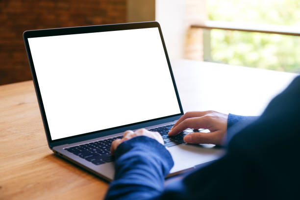 istock a woman using and typing on laptop computer keyboard with blank white desktop screen 1176692036