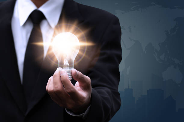 Innovation and inspiration concept, man holding bulb lamp white background.