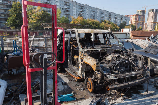 istock A burnt car after a fire or an accident in a parking lot covered with rust and black coal with scattered spare parts around. Robbery, arson, terrorism. 1176692210