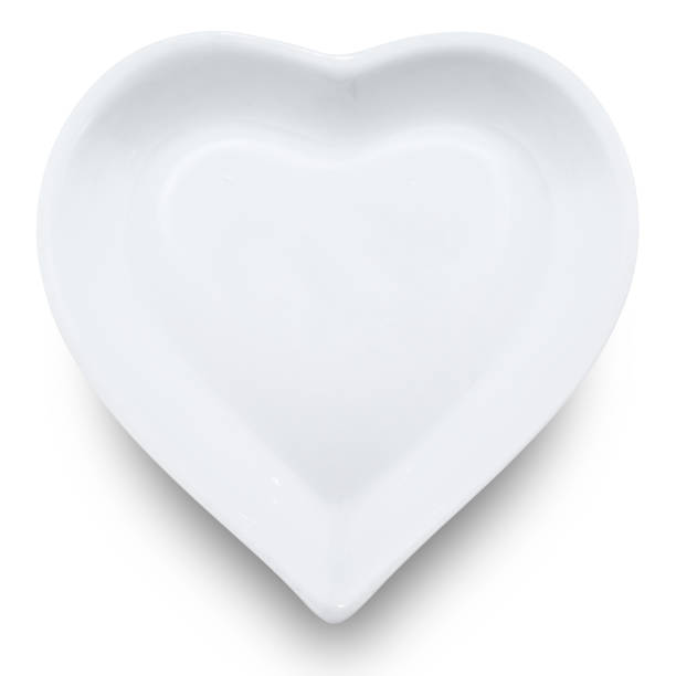 istock White plate in shape of heart isolated on white background. 1176692892