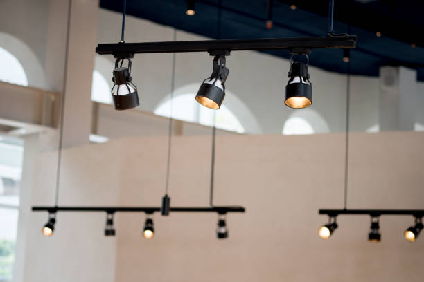 Spotlights under the ceiling on the wall decoration in cafe Spotlights under the ceiling on the wall decoration in cafe recessed light stock pictures, royalty-free photos & images