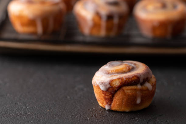 istock Homemade baked cinnamon rolls baked in a cookie sheet with icing. 1176696783