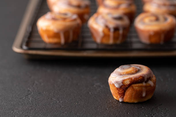 istock Homemade baked cinnamon rolls baked in a cookie sheet with icing. 1176696792