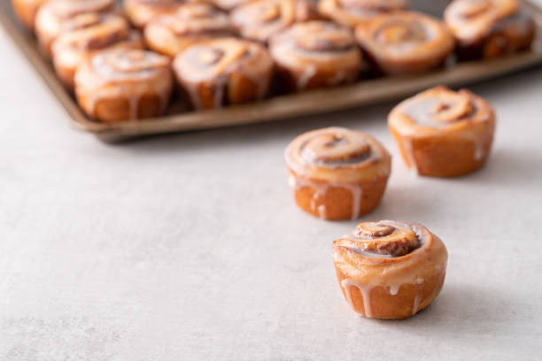 istock Homemade baked cinnamon rolls baked in a cookie sheet with icing. 1176696863