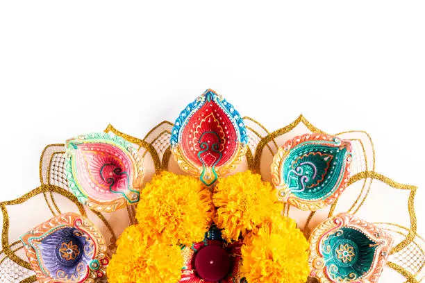 Photo of Happy Diwali - Clay Diya lamps lit during Dipavali, Hindu festival of lights celebration. Colorful traditional oil lamp diya on white background