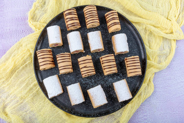 istock Sponge cake roll, with chocolate, vanilla and berry cream, different swiss rolls collection for use in packaging. 1176701763